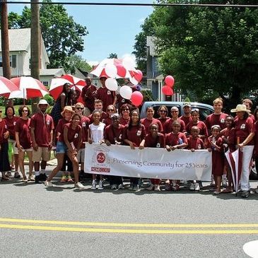 Picture from a previous 4th of July parade. HOMECorp employees, volunteers and supporters standing i